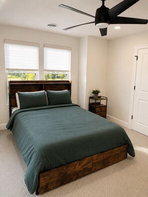 A bedroom with a bed, a ceiling fan, a nightstand, and a window. - Luxurious Hidden Gem in Suburbs of Cleveland OH (Gates Mills)