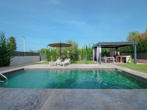 A swimming pool with two lounge chairs and a covered seating area. - Villa Maslina by Interhome (Dracevac)