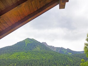 A mountain landscape with a forested area and a wooden structure. - Chalet la Chapelle by Interhome (La Chapelle d'Abondance)