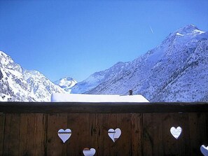A wooden structure with heart-shaped cutouts, overlooking a snowy mountain landscape. - Chalet Le Haut by Interhome (Champagny-en-Vanoise)