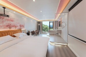 A modern hotel room with a large bed, a dining area, and a view of the outdoors. - Xishan Yangjiajie Scenic Lodge (Zhangjiajie)