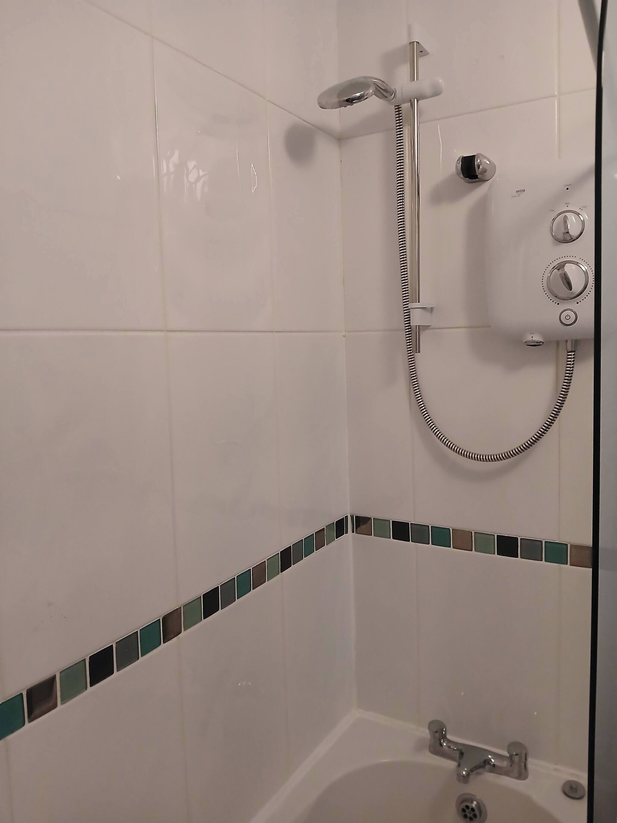 A bathroom with a shower, a bathtub, and a toilet.