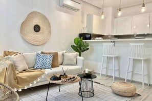 A modern living room with a sofa, coffee table, and a large decorative shell on the wall. - Le Bohémien Signature Apartment in La Marsa (La Marsa)