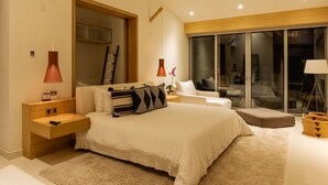 Een moderne slaapkamer met een groot bed, nachtkastjes, een lamp, een raam en een schuifpui naar een balkon.