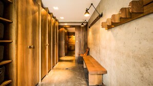 A hallway with wooden lockers, a bench, and wall-mounted shelves. - Chalet Noyer - Luxury 4 bedroom chalet only a short walk from Chamonix centre (Chamonix)