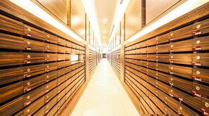 A long, narrow hallway with wooden paneling on both sides and a bright, well-lit ceiling. - 2 Bedroom High Floor Sea View Unit (Pattaya)
