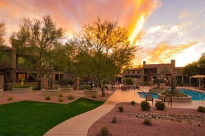 A resort with a swimming pool, outdoor seating, and a landscaped garden. - Grayhawk Townhome in Northern Scottsdale (Scottsdale)