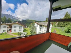 A balcony with a view of a residential area, including houses and mountains. - I dr Rehwiesa C21 Appartement/Fewo, Bad, WC, 4-Bettwohnung 4-Bettwohnung by Interhome (Arosa)
