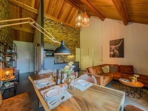 A modern kitchen with a central island, wooden ceiling, and pendant lighting. - Spacious holiday apartment by a lake in the Alps (Hermagor-Pressegger See)
