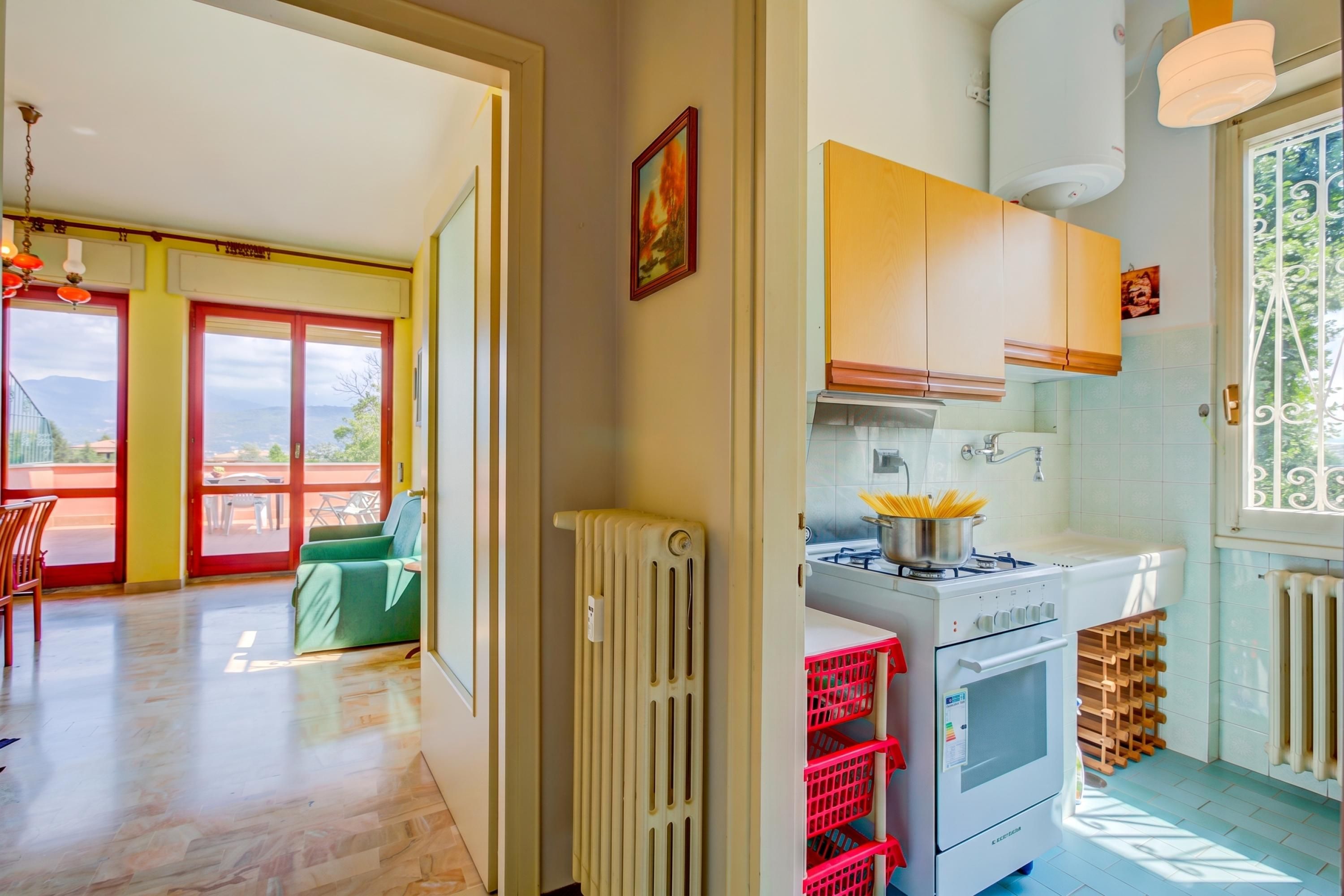 A kitchen with a stove, oven, and a view of the outdoors.