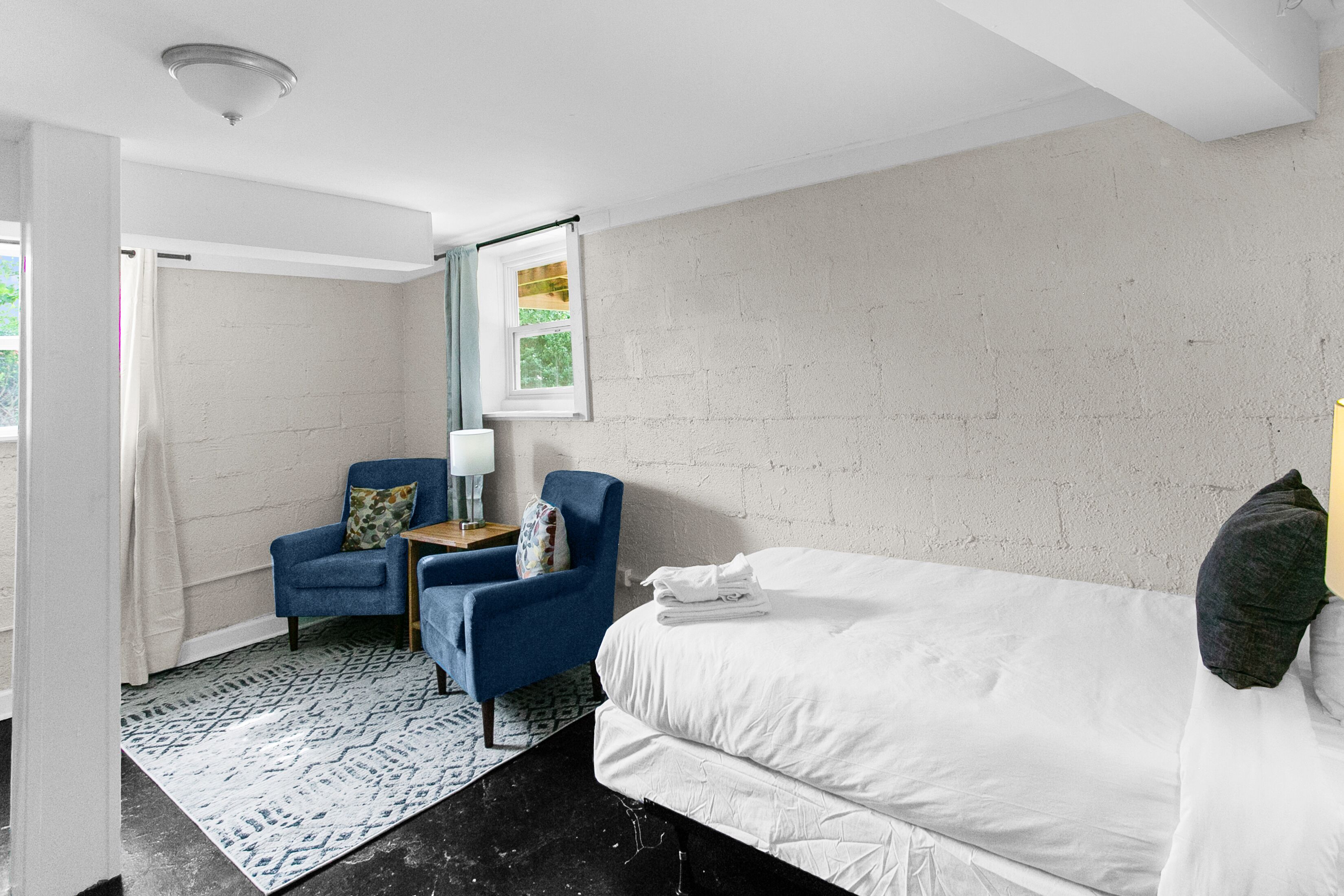 Enjoy a versatile twin bedroom in Unit B featuring a cozy sitting area—perfect for relaxing, reading, or taking a quiet break from the group.