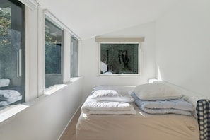A bedroom with a bed, pillows, a window, and a view of trees. - Charming holiday home in beautiful Asserbo (Liseleje)