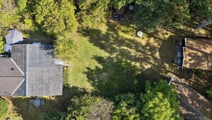 An aerial view of a residential property with a sloped roof, a fenced yard, and a small patio area. - Charming holiday home in beautiful Asserbo (Liseleje)