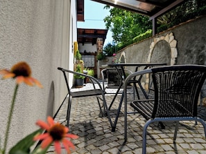 An outdoor patio area with stone flooring and metal furniture. - House Sofija by Interhome (Vrtlinovec)