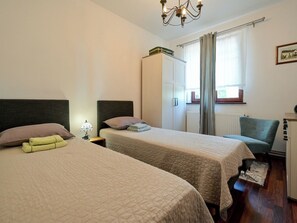 A hotel room with two beds, a wardrobe, a chair, and a desk. - House Sofija by Interhome (Vrtlinovec)