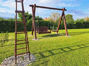 A wooden swing set with a bench in a grassy outdoor area. - House Tilia Mellis by Interhome (Lužan Biškupečki)