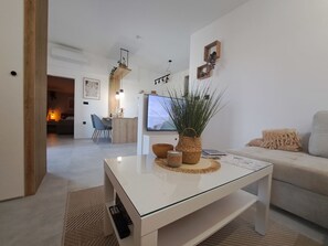 A modern living room with a glass coffee table, a sofa, and a TV. - House Tilia Mellis by Interhome (Lužan Biškupečki)