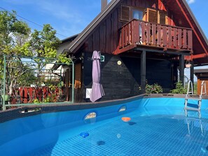 A swimming pool with a wooden deck and a covered area with a balcony. - House Rukova Hiža by Interhome (Donja Stubica)