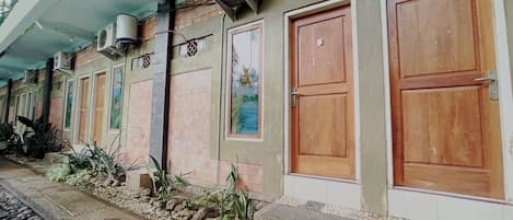 A building with multiple doors, air conditioning units, and a tiled entrance.