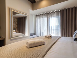 A hotel room with a large bed, a mirror, a window with curtains, and a headboard. - Vacation home Alfa by Interhome (Lovinac)