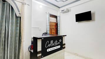 A reception desk with a sign reading 'Collection Company-Service'.