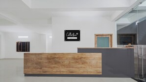 A reception desk with a wooden panel and a black sign above it. - Super Collection O Banaras Railway (Varanasi)