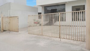 A gated entrance to a building with a concrete floor and a clear sky. - Super Collection O Banaras Railway (Varanasi)
