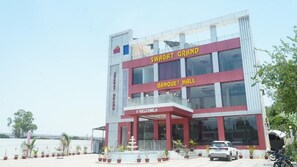 A multi-story building with a prominent sign reading 'SWAGAT GRAND BANQUET HALL' and a welcoming entrance.