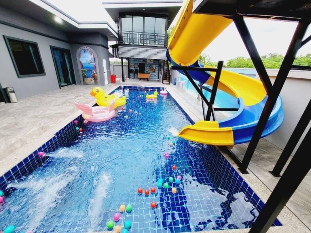 Una piscina con uno scivolo e giochi gonfiabili.