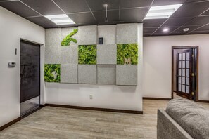 A hallway with a textured wall, a door, and a bench.