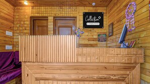 A wooden reception desk with a sign above it, a window, and a purple couch. - Super Collection O Hill View Point (Kodaikanal)