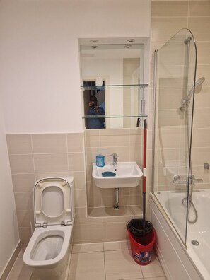 A bathroom with a toilet, sink, and shower. - A friendly budget room that delivers comfort stay (Woolston)