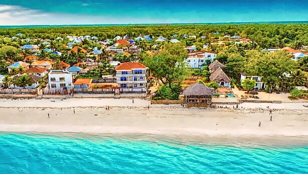 A coastal resort with beachfront properties, a swimming pool, and clear turquoise waters. - Private Beachfront Apartment with Ocean Views in Zanzibar (Zanzibar, Uroa)