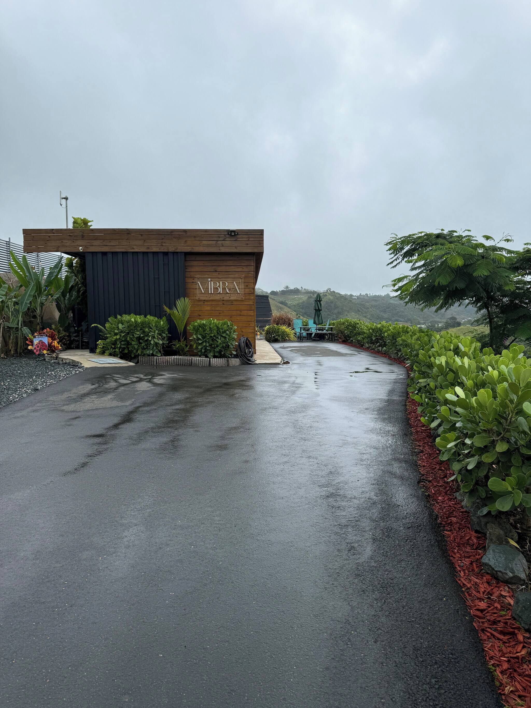 A building with a sign reading 'VIBRA' and a paved entrance.