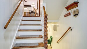 A staircase with wooden handrails and a wall-mounted heart-shaped sign with a WiFi password. - Private Yard & Patio! Overland Park Group Getaway (Overland Park)