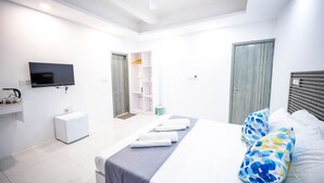 A modern hotel room with a bed, a television, a small desk, and a wardrobe. - Aquatic Mathiveri (Alifu Alifu Mathiveri)