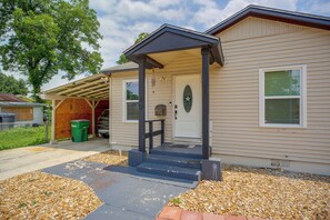 A residential house with a covered porch, a front door, and a garage. - Near San Antonio River Walk w/ Fenced Yard (San Antonio)