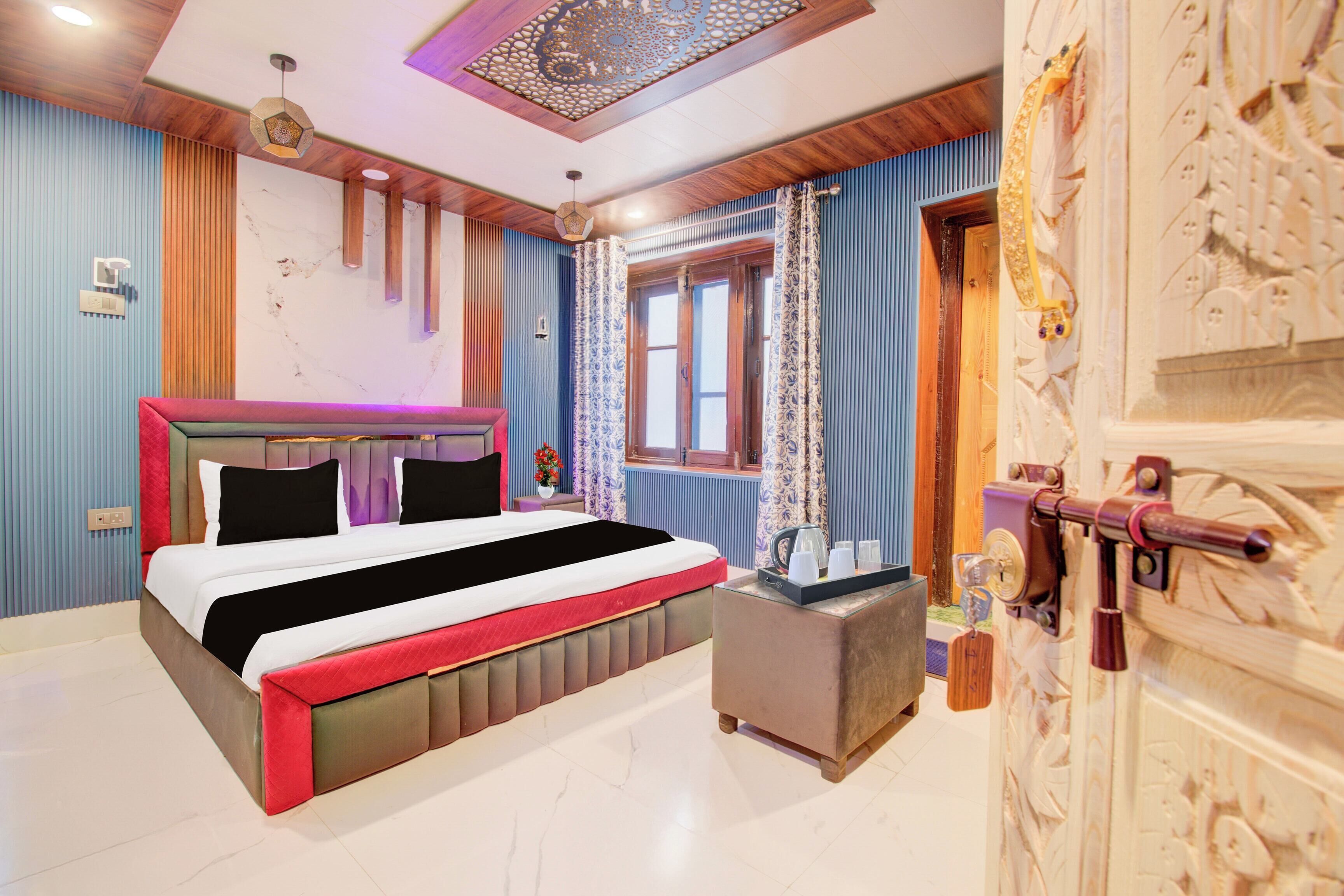 A bedroom with a bed, bedside table, and a decorative wall panel.