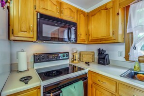A kitchen with wooden cabinets, a microwave, an oven, and a sink. - Stunning Views & Sunrises! Pappy's Place in Murphy (Murphy)