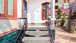 A staircase with metal railings leading to a building entrance. - Collection O Brein Nishat (Srinagar)