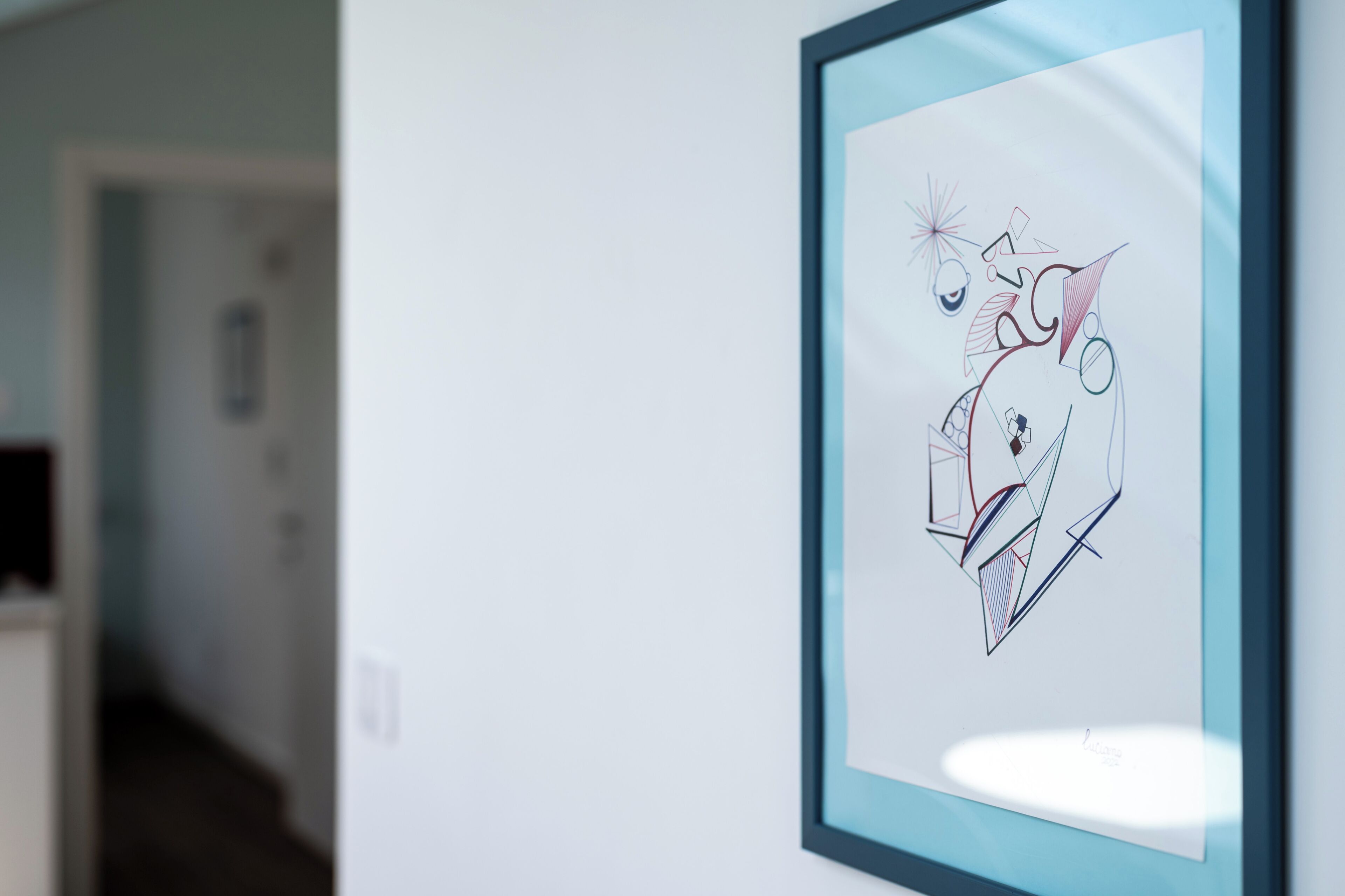 A framed abstract artwork on a wall.