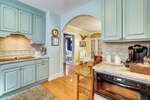 A kitchen with light blue cabinets, a coffee maker, and a microwave. - Walkable Victorian Cottage in Historic Ocean Grove (Ocean Grove)