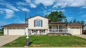A two-story house with a front porch, garage, and a well-maintained lawn. - Grill & Fenced Yard! Longmont Home, Walk to Parks (Longmont)