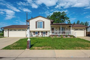 A two-story house with a front porch, garage, and a well-maintained lawn. - Grill & Fenced Yard! Longmont Home, Walk to Parks (Longmont)