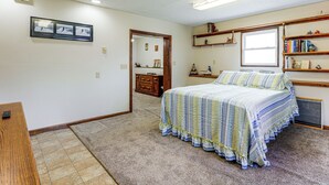 A bedroom with a bed, a dresser, a mirror, and a bookshelf. - Grill & Fenced Yard! Longmont Home, Walk to Parks (Longmont)