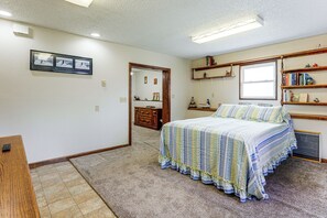 A bedroom with a bed, a dresser, a mirror, and a bookshelf. - Grill & Fenced Yard! Longmont Home, Walk to Parks (Longmont)