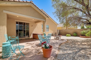 A patio area with outdoor furniture, a hot tub, and a potted plant. - Vegas Extended Retreat w/ Furnished Patio (Las Vegas)