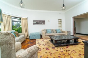 A living room with a sofa, a coffee table, and a patterned rug.