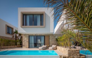A modern two-story house with a swimming pool, stone walls, and a balcony with outdoor seating. - Luxurious home in Tkon (Tkon)