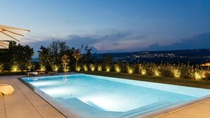 A swimming pool with a view of a cityscape at dusk. - Luxury Villa Lara With Heated Pool, Hot-tub and Sauna - Six Bedroom Villa With Pool (Zmijavci)